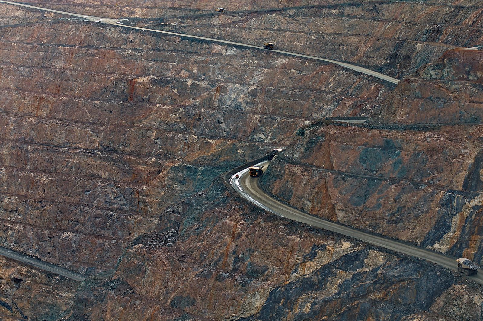 Open-pit mine with haul trucks on haul roads